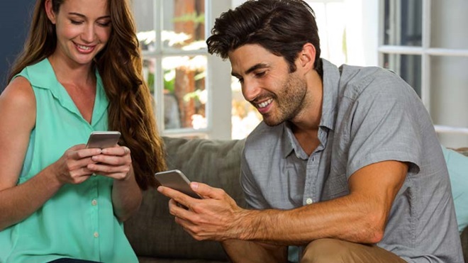 casal jovem adulto em casa, cada um a usar o seu telemóvel