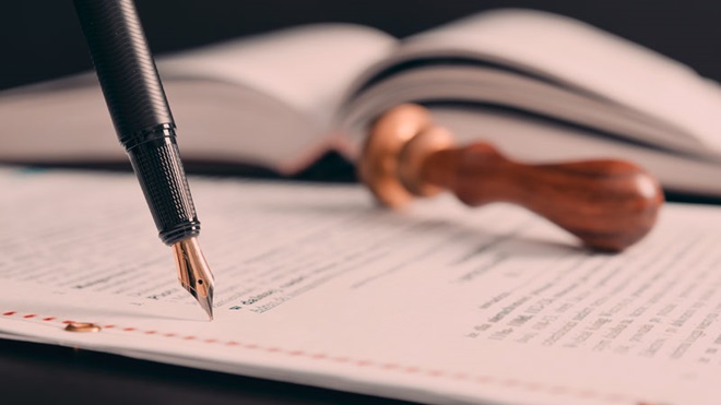 Grande plano de documento legal com caneta e carimbo ao pé; alusão ao novo certificado sucessório europeu