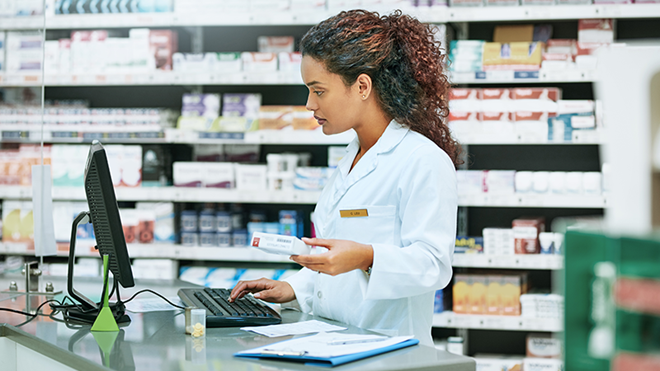 mulher em farmácia no computador