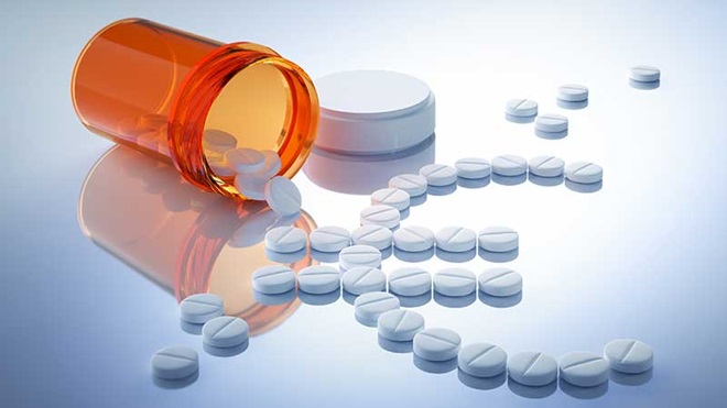 Comprimidos a saírem do frasco e a formarem o símbolo do euro