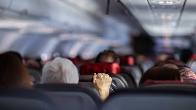 Pessoas agarrada ao banco no interior do avião