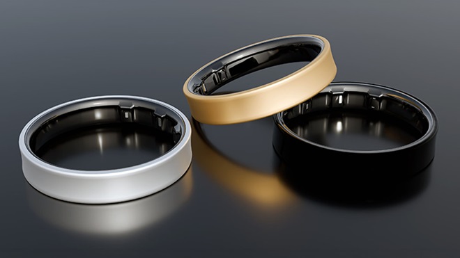 Três smart rings preto, prateado e dourado, num fundo preto