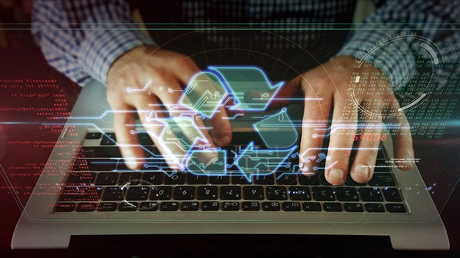 Mãos de um homem com camisa de xadrez azul sobre as teclas de um computador portátil e símbolo da reciclagem em transparência por cima