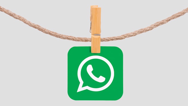 logótipo do whatsapp preso por uma mola numa corda