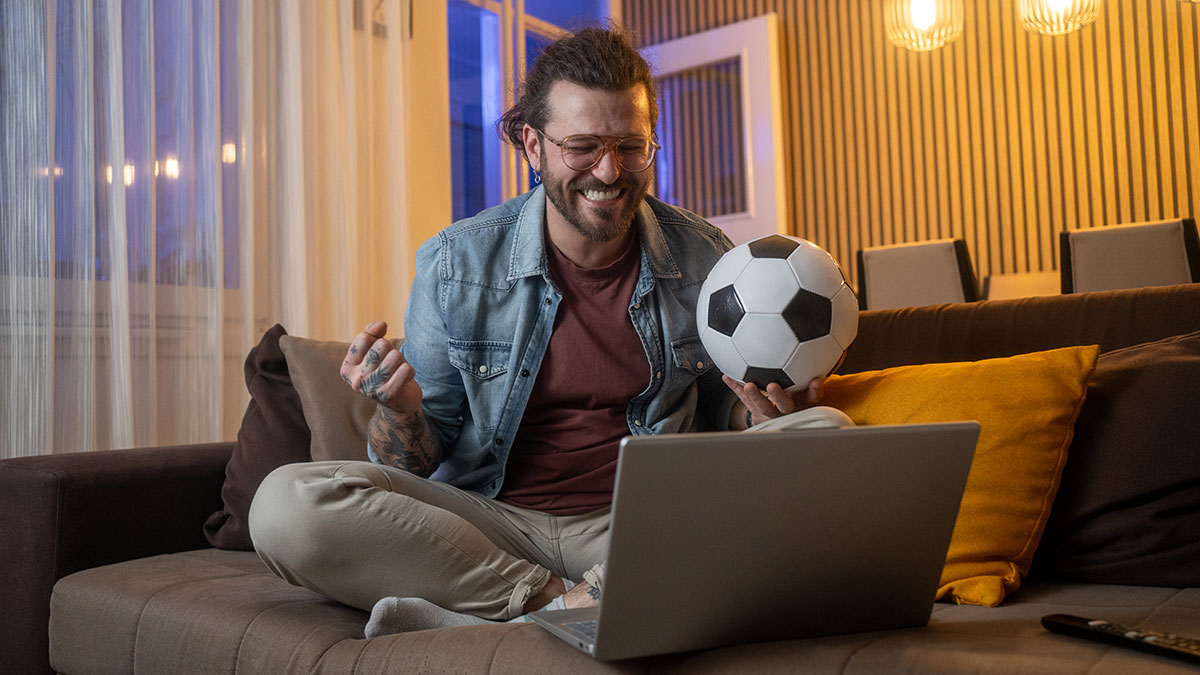 Homem a ver futebol no computador